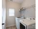 Functional laundry room featuring modern side-by-side washer and dryer with practical shelving at 968 Autumn Glen Ct, Clover, SC 29710