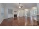 Spacious living room with hardwood floors, fireplace, built-in shelving, and ample natural light at 968 Autumn Glen Ct, Clover, SC 29710
