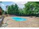 In-ground swimming pool with stairs, complemented by a fire pit and wooden deck, creating a relaxing outdoor living space at 968 Autumn Glen Ct, Clover, SC 29710