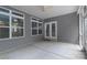 A screened porch has a fan, grey siding, and a set of French doors and windows at 968 Autumn Glen Ct, Clover, SC 29710