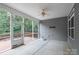 The screened porch has grey siding, a fan, and a door to the deck at 968 Autumn Glen Ct, Clover, SC 29710