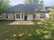 Rear exterior of the home, with a patio area and a spacious backyard at 978 Stinson Glen Ln, Charlotte, NC 28214