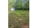 View of the backyard with a storage shed and green space at 978 Stinson Glen Ln, Charlotte, NC 28214