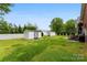Backyard with white fencing, well-maintained lawn, and storage sheds at 102 Sussex Ave, Cherryville, NC 28021