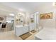 Bright, all-white bathroom with a double vanity that leads into the kitchen at 102 Sussex Ave, Cherryville, NC 28021