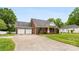 View of the brick home with an attached two-car garage and a long driveway at 102 Sussex Ave, Cherryville, NC 28021