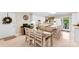 White kitchen features an island with barstool seating and a dining area for Gathering meals at 102 Sussex Ave, Cherryville, NC 28021