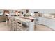 Bright kitchen with white cabinets, modern appliances, and a spacious island with bar stool seating at 102 Sussex Ave, Cherryville, NC 28021