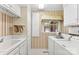 Charming laundry room with cabinets, sink, window, and washer and dryer at 102 Sussex Ave, Cherryville, NC 28021
