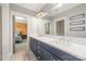 Bathroom featuring dual sinks, a large mirror, and a doorway leading to the bedroom at 1045 Spyglass Ln, Waxhaw, NC 28173