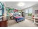 Unique bedroom with graffiti wall, desk area, and ample natural light from the large window at 1045 Spyglass Ln, Waxhaw, NC 28173