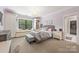 Charming bedroom with window seat, chandelier, and walk-in closet boasts ample natural light at 1045 Spyglass Ln, Waxhaw, NC 28173