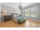 Cozy bedroom with hardwood floors, stylish lighting, and a comfortable atmosphere at 1045 Spyglass Ln, Waxhaw, NC 28173