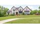 Stunning white brick home with a beautifully landscaped lawn and a long, curved walkway at 1045 Spyglass Ln, Waxhaw, NC 28173