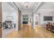 Open floor plan with wood floors, arched entryways, and views of the office, living room, and dining room at 1045 Spyglass Ln, Waxhaw, NC 28173