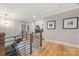 Upstairs hallway with wooden floor and railing at 1045 Spyglass Ln, Waxhaw, NC 28173