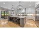 Spacious kitchen featuring a large center island with seating, stainless steel appliances, and hardwood floors at 1045 Spyglass Ln, Waxhaw, NC 28173