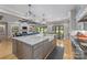 Gourmet kitchen showcasing a large island, stainless steel appliances, and open access to the living room at 1045 Spyglass Ln, Waxhaw, NC 28173