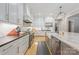 Modern kitchen with white cabinetry, stainless steel appliances, a large island, and hardwood floors at 1045 Spyglass Ln, Waxhaw, NC 28173