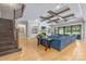 Bright living room boasting a coffered ceiling, built-in shelving, a brick fireplace, and light hardwood floors at 1045 Spyglass Ln, Waxhaw, NC 28173