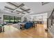 Open concept living area featuring a large blue sectional, hardwood floors, and access to the kitchen at 1045 Spyglass Ln, Waxhaw, NC 28173