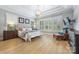 Bright and airy main bedroom with large windows, hardwood floors, and stylish decor at 1045 Spyglass Ln, Waxhaw, NC 28173