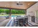 Outdoor seating area with a covered patio, ceiling fan, and views of the pool and backyard at 1045 Spyglass Ln, Waxhaw, NC 28173