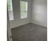 Empty bedroom featuring gray carpet and two windows at 113 Stoney Ln, Cherryville, NC 28021
