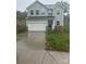 Two story home with gray siding, white trim, two car garage and concrete driveway at 113 Stoney Ln, Cherryville, NC 28021