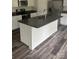 Kitchen island with granite countertop, stainless appliances, white cabinets and gray wood-look flooring at 113 Stoney Ln, Cherryville, NC 28021