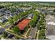 An aerial view of a tennis court with surrounding residential neighborhood and green trees at 11621 Mount Argus Dr, Cornelius, NC 28031