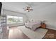 Cozy bedroom features a ceiling fan, natural light, and neutral tones at 11621 Mount Argus Dr, Cornelius, NC 28031