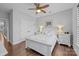 Comfortable bedroom with hardwood floors, ceiling fan, and white furniture at 11621 Mount Argus Dr, Cornelius, NC 28031