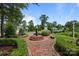 Charming brick path leads to an elegant entrance fountain with manicured landscaping at 11621 Mount Argus Dr, Cornelius, NC 28031