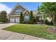 Charming two-story home featuring a beautifully landscaped front yard, three-car garage, and inviting front porch at 11621 Mount Argus Dr, Cornelius, NC 28031