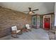 Inviting front porch with stone facade, rocking chairs, and ceiling fan; perfect for enjoying the outdoors at 11621 Mount Argus Dr, Cornelius, NC 28031