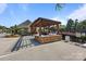 A beautiful grilling station with a stone bar, wooden pergola, and built-in grill at 11621 Mount Argus Dr, Cornelius, NC 28031
