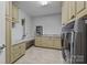 Well-organized laundry room with built-in storage cabinets, countertops, and modern appliances at 11621 Mount Argus Dr, Cornelius, NC 28031