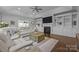 Spacious living room with a cozy fireplace, built-in shelving, and plush seating for relaxation at 11621 Mount Argus Dr, Cornelius, NC 28031
