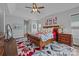 Spacious main bedroom featuring a ceiling fan and an eye-catching red, gray, and black floral carpet at 11621 Mount Argus Dr, Cornelius, NC 28031