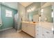 Well-maintained bathroom featuring ample counter space and a shower with patterned curtains at 13360 Old Compton Ct, Pineville, NC 28134