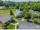 Aerial view of a home with a well manicured lawn and mature trees at 13360 Old Compton Ct, Pineville, NC 28134