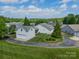 Aerial view showcasing a home with an attached garage and surrounding green lawn at 13360 Old Compton Ct, Pineville, NC 28134