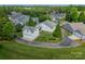 Aerial view of a home with an attached garage and surrounding green lawn in a neighborhood at 13360 Old Compton Ct, Pineville, NC 28134