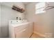 Practical laundry room with washer, dryer, and overhead storage shelves at 13360 Old Compton Ct, Pineville, NC 28134