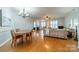 Open-concept living and dining area with hardwood floors and abundant natural light at 13360 Old Compton Ct, Pineville, NC 28134