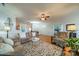 Spacious living room with hardwood floors, ceiling fan, and views into the dining room at 13360 Old Compton Ct, Pineville, NC 28134