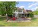 Spacious backyard with a patio, seating, and a well-maintained lawn, perfect for outdoor enjoyment at 13406 Ada Ct, Charlotte, NC 28213