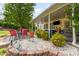 Beautiful backyard featuring a covered patio with outdoor seating and lush landscaping at 13406 Ada Ct, Charlotte, NC 28213