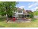 Spacious backyard with a patio, seating, and a well-maintained lawn, perfect for outdoor enjoyment at 13406 Ada Ct, Charlotte, NC 28213
